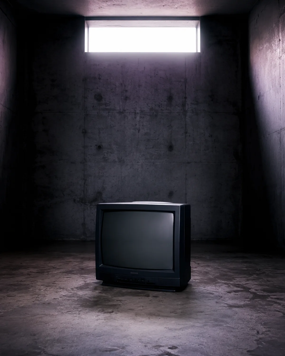 An old television in a dimly lit concrete room, illustrative image for the article