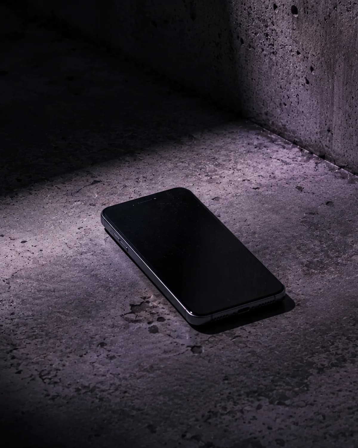 A phone lying on a concrete floor in dim light, illustrative image for the article